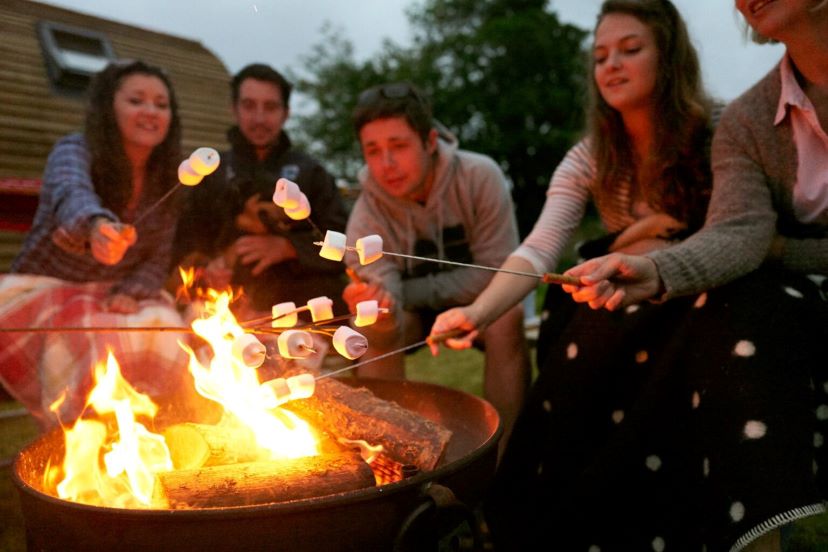 Toasting marshmallows round the camp fire